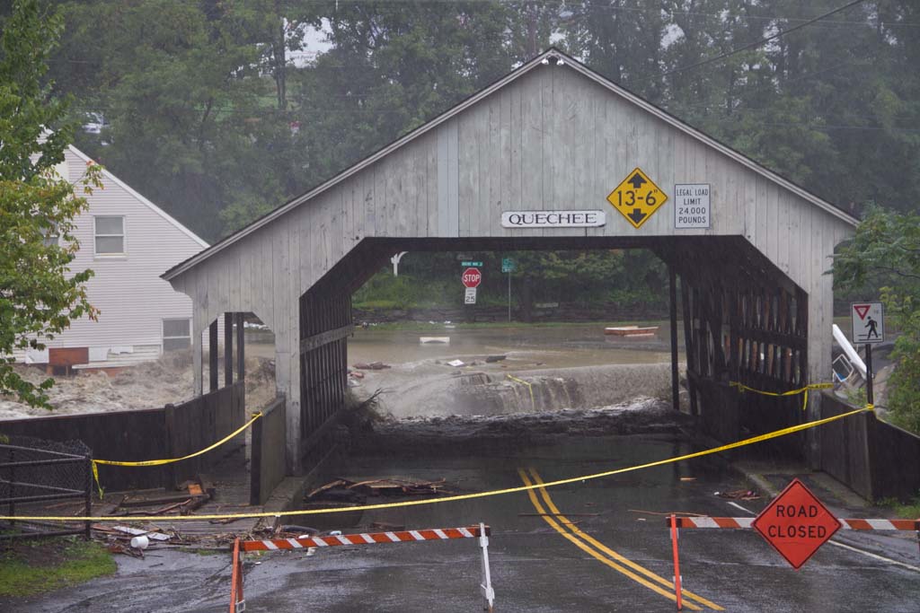 Closed covered bridge in front of flood waters from Tropical Storm Irene in Quechee, Vermont