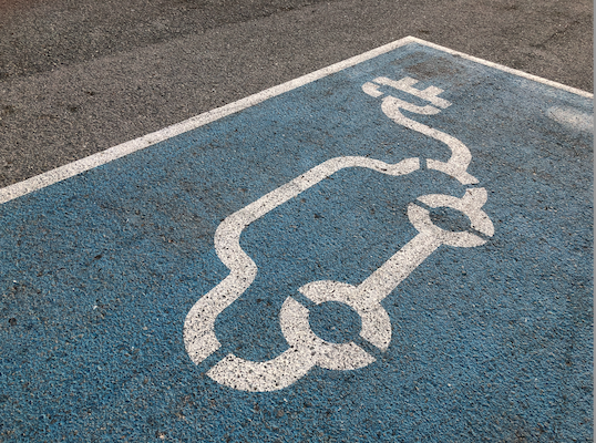 electric car symbol on tarmac